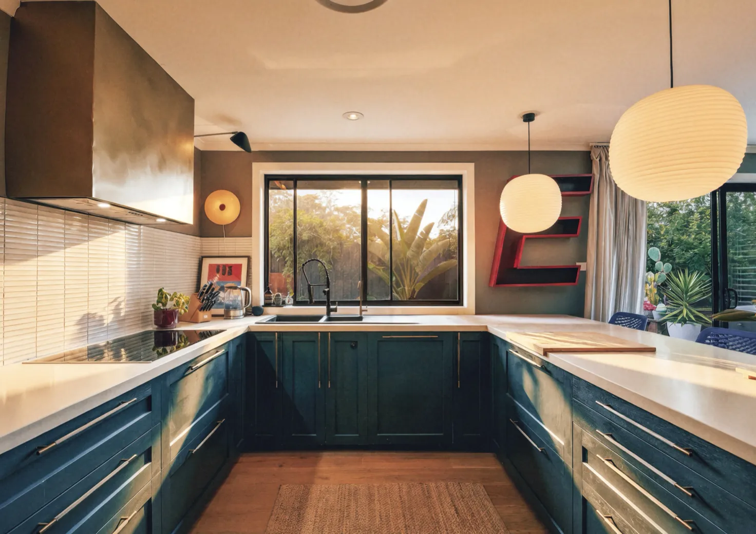 Kitchen with navy cabinetry and Caesarstone benchtops