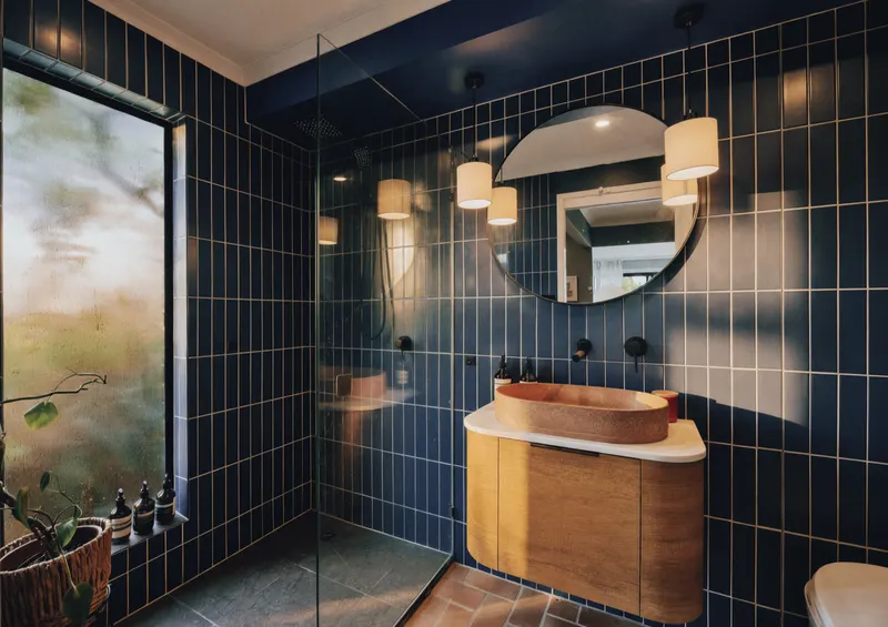 Bathroom with navy tiles and timber vanity